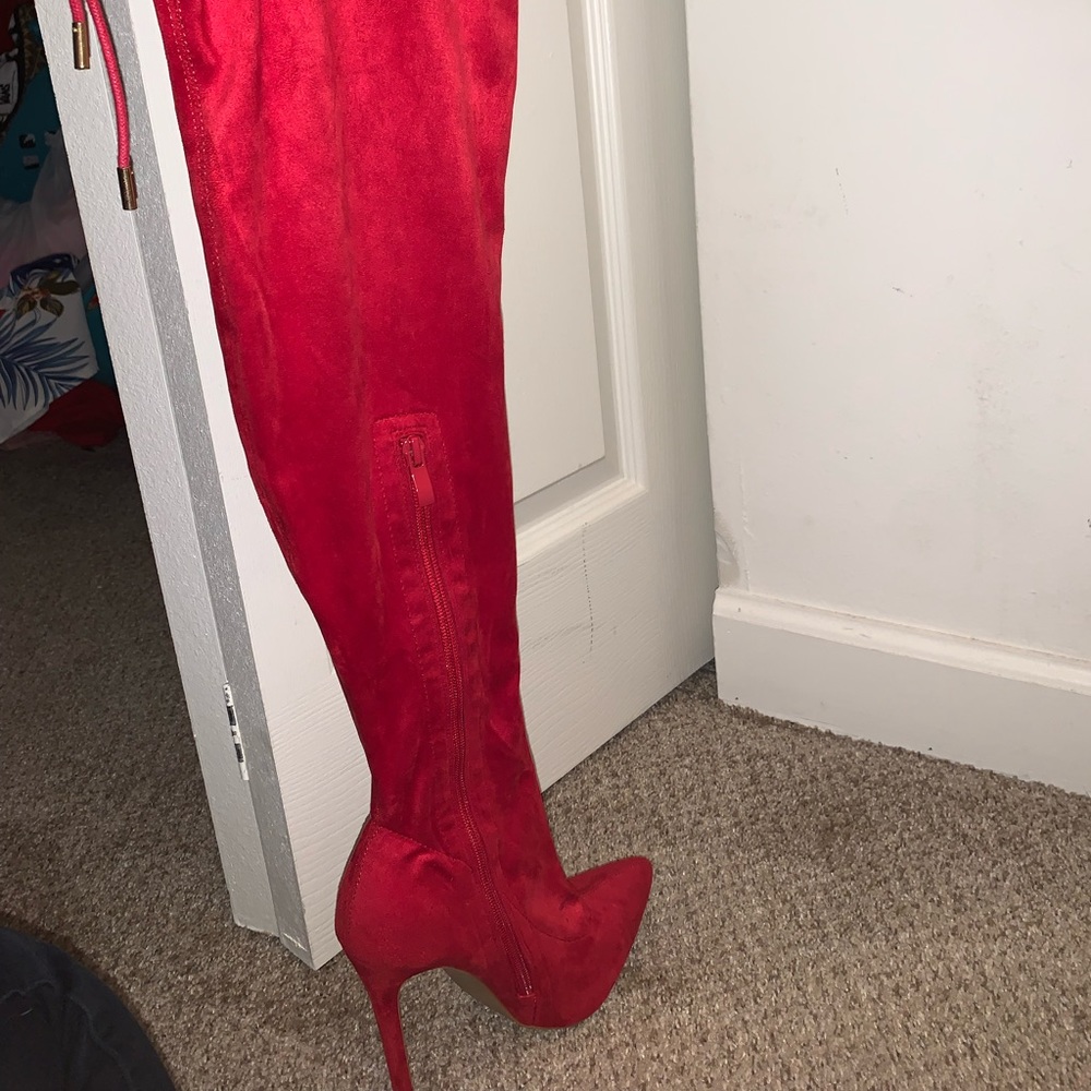Red knee high heel boots from Fashion Nova